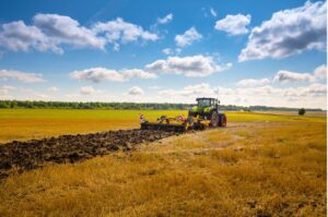 tractor with a heavy disc harrow in the field